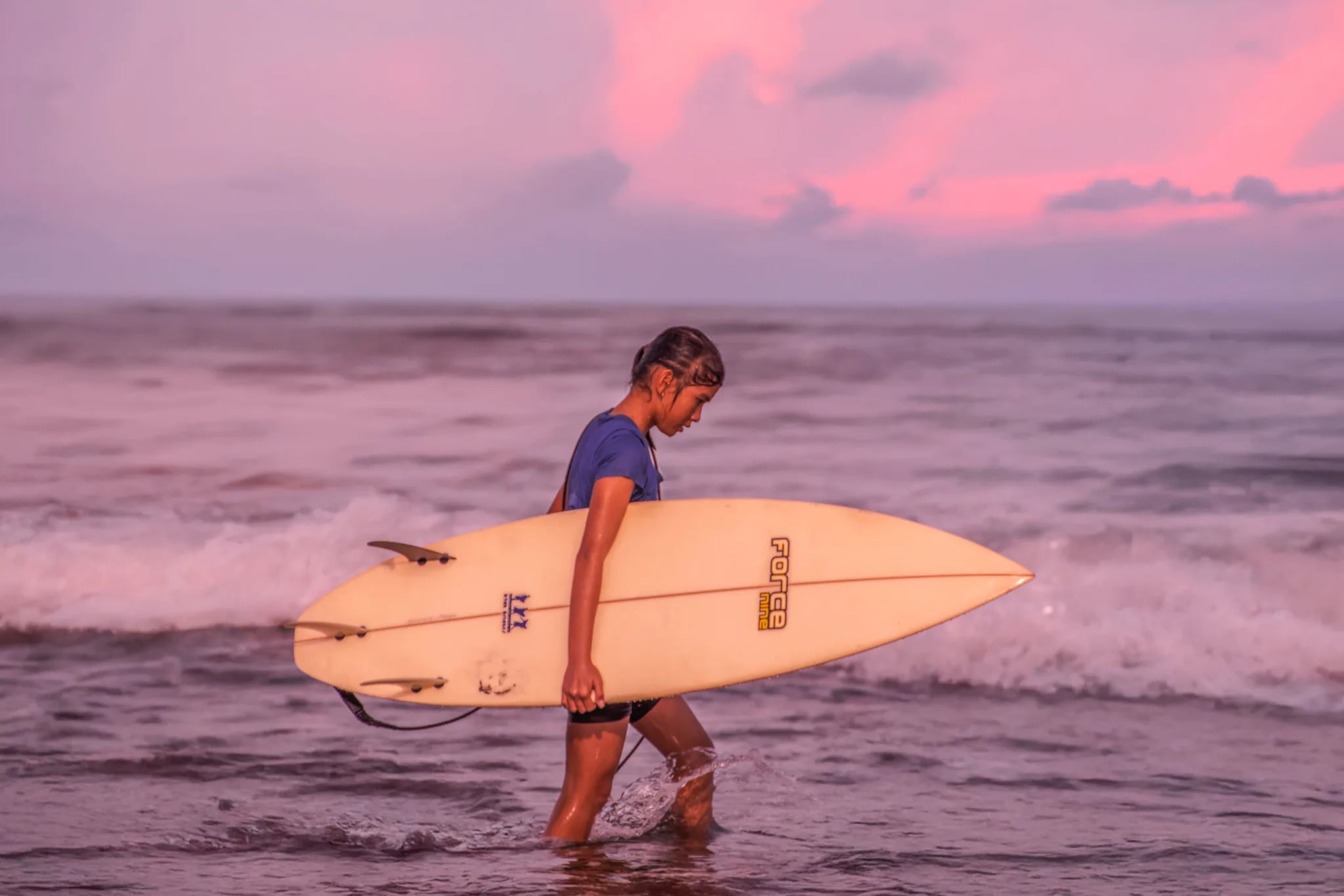 Surf instructor coaching a student on a Bali beach - GetSurf